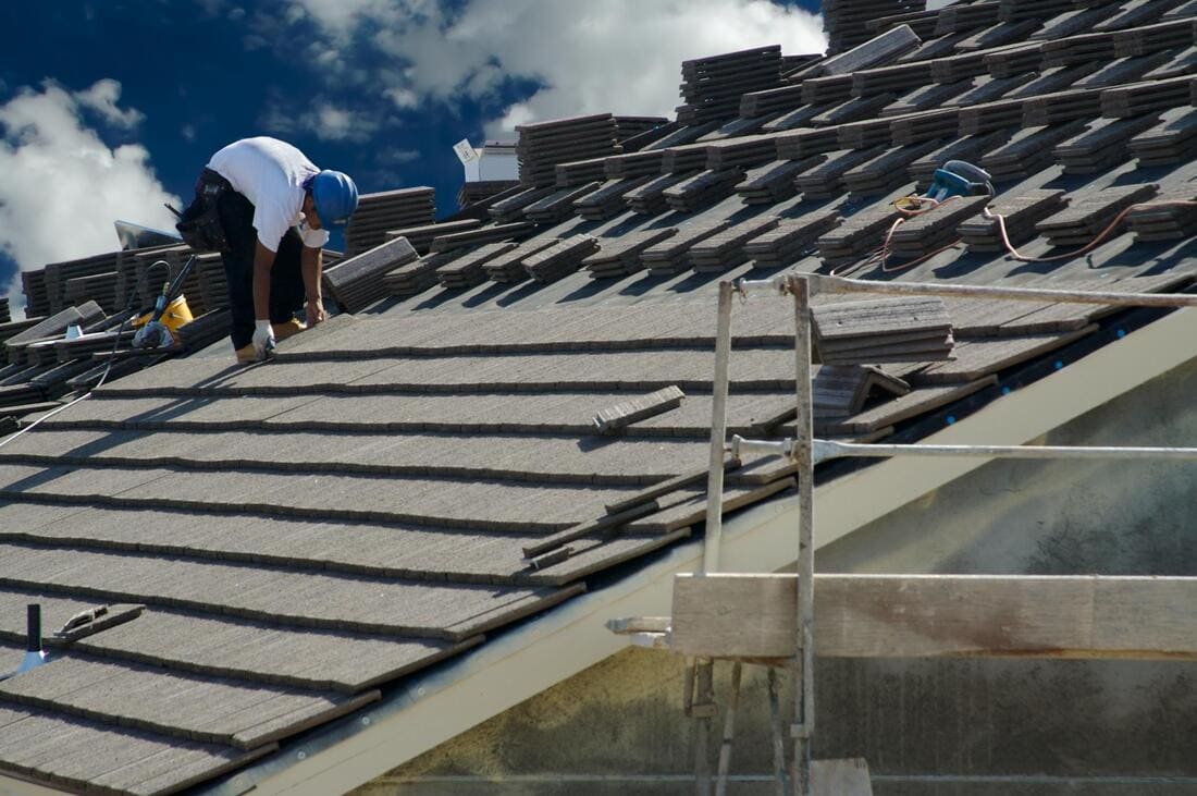Roofers preparing a tile roof system